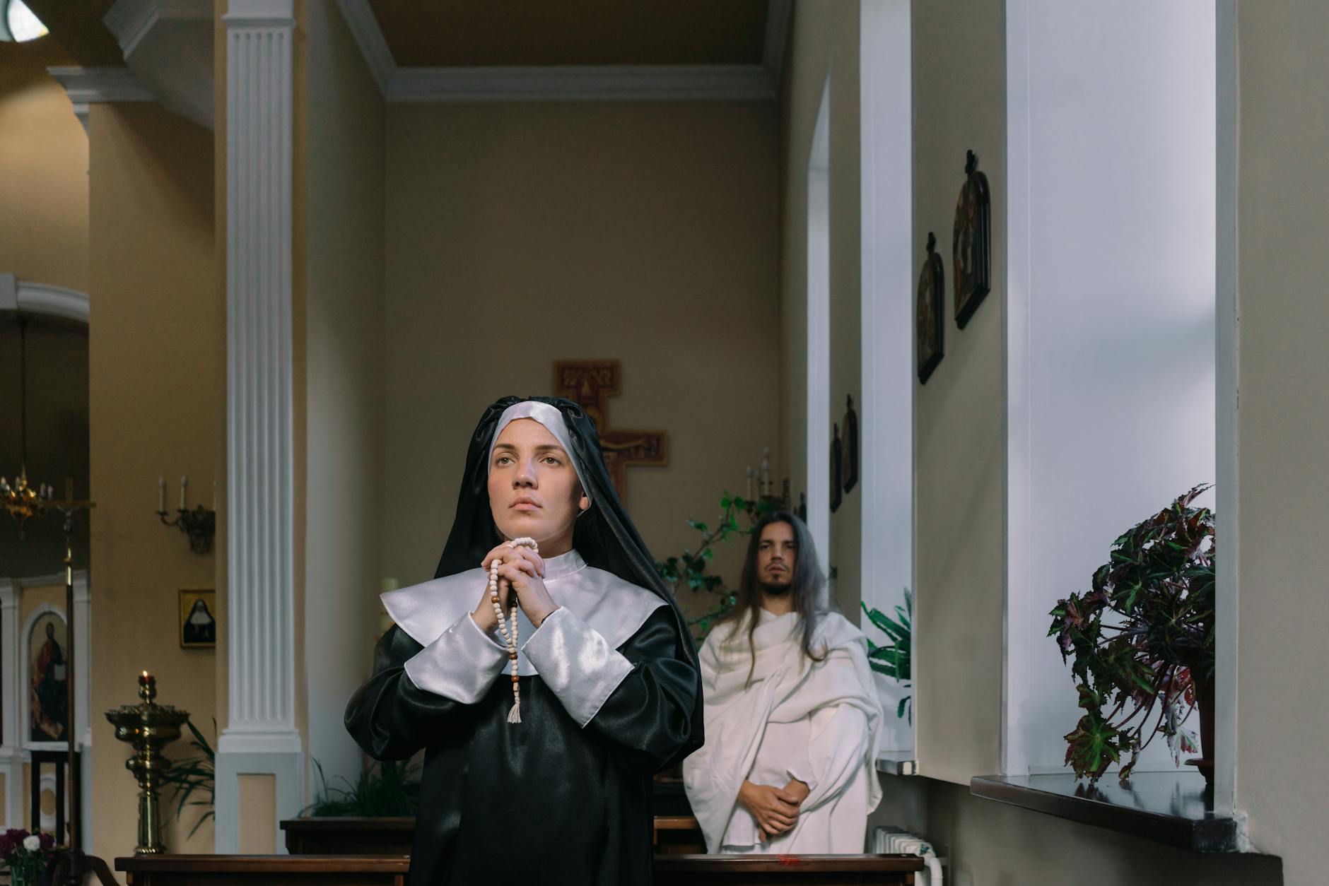 man and woman praying inside a church